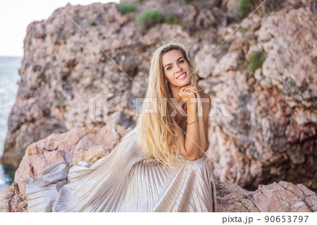 Woman tourist against the backdrop of rocks in Montenegro. Panoramic summer landscape of the beautiful green Royal park Milocer on the shore of the the Adriatic Sea, Montenegro Woman tourist against the backdrop of rocks in Montenegro. Panoramic summer landscape of the beautiful green Royal park Milocer on the shore of the the Adriatic Sea, Montenegro 90653797