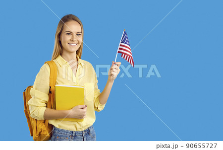 Smiling girl student with backpack and American flag 90655727
