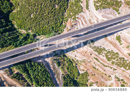 Aerial view on highway bridge in the mountain. Drone, copter view. Aerial view on highway bridge in the mountain. Drone, copter view. 90656889