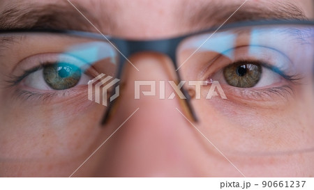 Close up of man's face glasses. Boy opening his beautiful eyes. European young male model green eyes looking at camera. 90661237