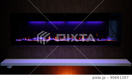 view on electric fireplace with artificial sparkling flame, decor for the interior, orange flame on crystals view on electric fireplace with artificial sparkling flame, decor for the interior, orange flame on crystals 90661307