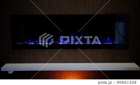 view on electric fireplace with artificial sparkling flame, decor for the interior, blue flame on crystals view on electric fireplace with artificial sparkling flame, decor for the interior, blue flame on crystals 90661308