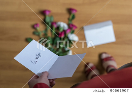 woman with paper letter and word goodbye on a floor. Heart broken concept. Copy Space woman with paper letter and word goodbye on a floor. Heart broken concept. Copy Space 90661907