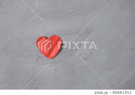 crumpled paper heart on the concrete floor.  Broken relationships in bad Valentine's day. concept. 90661952