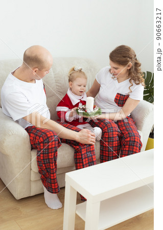 Child girl dressed in christmas dress with cochlear implants having fun at home - diversity and hearing aid and innovating technologies for treatment of deafness. Copy space and place for advertising Child girl dressed in christmas dress with cochlear implants having fun at home - diversity and hearing aid and innovating technologies for treatment of deafness. Copy space and place for advertising 90663217