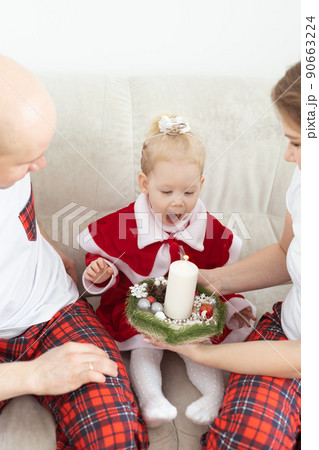 Baby child with hearing aid and cochlear implant having fun with parents in christmas room. Deaf , diversity and health concept Baby child with hearing aid and cochlear implant having fun with parents in christmas room. Deaf , diversity and health concept 90663224