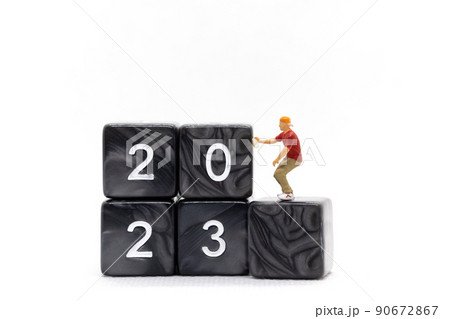 Miniature People Graffiti Artist spraying Number 2023 On Block 90672867