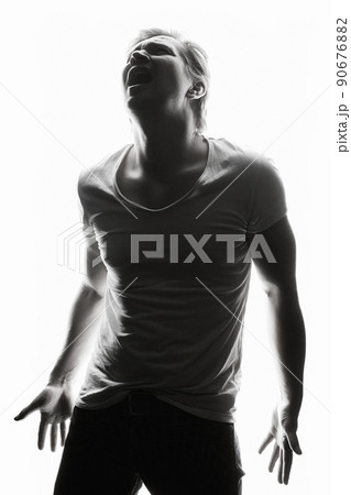 Screaming Man. Silhouette portrait of a man. Emotion boy in a shirt Screaming Man. Silhouette portrait of a man. Emotion boy in a shirt 90676882