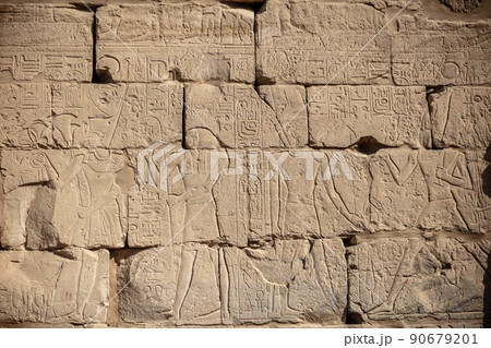 Different hieroglyphs on the walls and columns in the Karnak temple. Karnak temple is the largest complex in ancient Egypt. 90679201