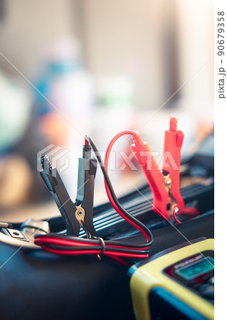 Charging battery and repair in motorcycle for start by portable trickle charger and clamp. 90679358