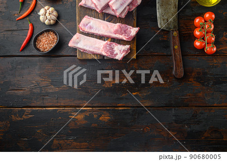 Pork rib with ingredients , with old butcher cleaver knife, on old dark wooden table , top view flat lay, with copy space for text Pork rib with ingredients , with old butcher cleaver knife, on old dark wooden table , top view flat lay, with copy space for text 90680005