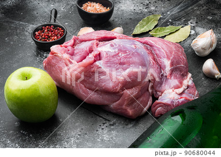 Pork roast ingredients, with apple dry cider, on black dark stone table background Pork roast ingredients, with apple dry cider, on black dark stone table background 90680044