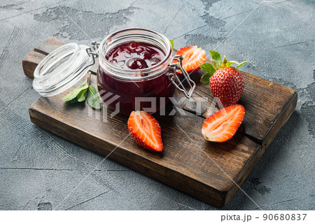 Homemade delicious strawberry jam and with fresh berries, on gray background 90680837
