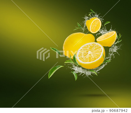 Water splash on fresh lime with tea leaves isolated on green background. Water splash on fresh lime with tea leaves isolated on green background. 90687942