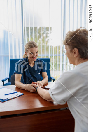 Therapist conducts a preventive examination of a woman and check her pulse in modern clinic Therapist conducts a preventive examination of a woman and check her pulse in modern clinic 90691048