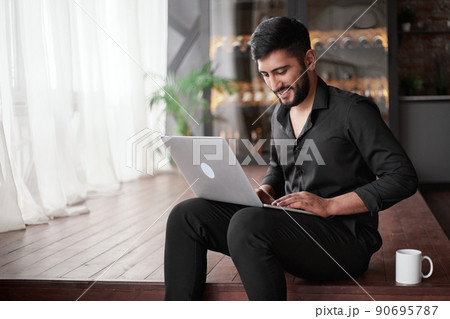 business owner using a laptop in his new store. 90695787