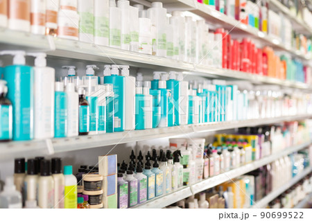 Hair care products on store shelves in supermarket 90699522