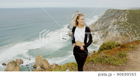Beautiful woman relaxes at Cabo da Roca in Portugal - Sintra Natural Park 90699565