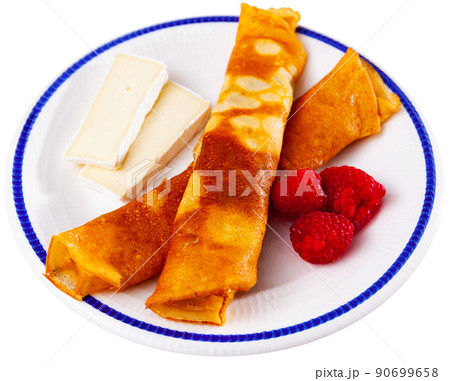 Pancakes with honey, raspberries and slices of cheese Pancakes with honey, raspberries and slices of cheese 90699658