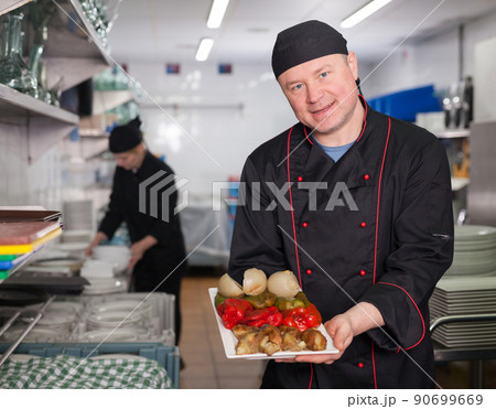 Chef showing right off stove dish Chef showing right off stove dish 90699669