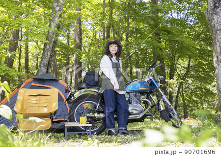 バイク女子ソロキャン女子イメージ　キャンプ場にバイクでツーリングに来た女性 90701696