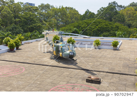 Ho Chi Minh, Vietnam - Oct 17, 2019 : old US Vietnam War helicopter UH-1 upon the roof of Independence Palace (Reunification Palace) in Ho Chi Minh City, Vietnam on Oct 17, 2019. 90702947