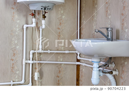 Tank style water heater, using electricity to heat water for home water supply. Tank style water heater, using electricity to heat water for home water supply. 90704223
