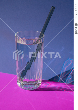 Reusable glass Straws in Glass with water on purple violet background Eco-Friendly Drinking Straw Set with cleaning brush. Zero waste, plastic free concept Reusable glass Straws in Glass with water on purple violet background Eco-Friendly Drinking Straw Set with cleaning brush. Zero waste, plastic free concept 90704622