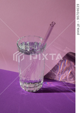 Reusable glass Straws in Glass with water on purple violet background Eco-Friendly Drinking Straw Set with cleaning brush. Zero waste, plastic free concept Reusable glass Straws in Glass with water on purple violet background Eco-Friendly Drinking Straw Set with cleaning brush. Zero waste, plastic free concept 90704639