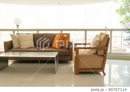 empty sofa and chair with pillows 90707114