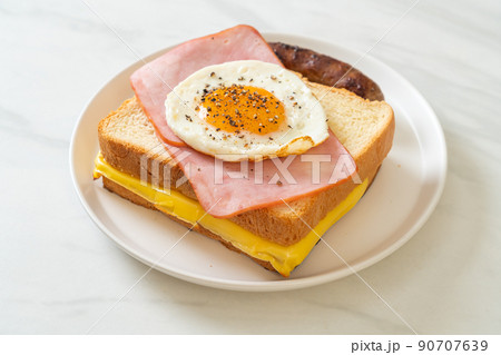 bread toasted cheese topped ham and fried egg with pork sausage 90707639