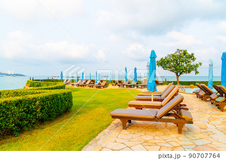 chair pool and umbrella around swimming pool 90707764