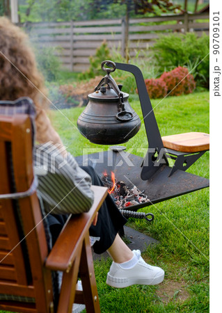 Cast iron pot over the fire Cast iron pot over the fire 90709101