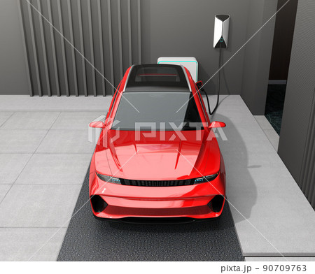 蓄電用バッテリー付きのスマートホームに充電している赤色の電動SUV。 蓄電用バッテリー付きのスマートホームに充電している赤色の電動SUV。 90709763
