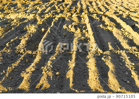 Excavator tracks on the ground texture. Mud ground earth soil trace tracks marks markings dry surface texture. Excavator tracks on the ground texture. Mud ground earth soil trace tracks marks markings dry surface texture. 90715105