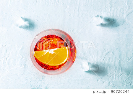 Aperol cocktail with an orange and ice cubes, Italian summer cold drink 90720244