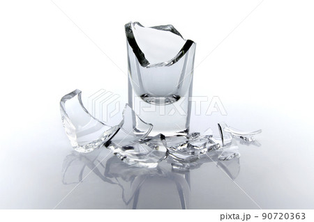 Shards of a broken glass goblet on a white background. Shards of a broken glass goblet on a white background. 90720363