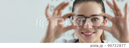 Woman eye doctor with eye test chart on background Woman eye doctor with eye test chart on background 90722877