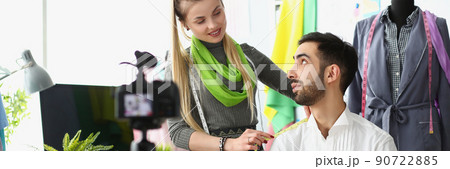 Woman designer measuring shoulder of her colleague on camera Woman designer measuring shoulder of her colleague on camera 90722885