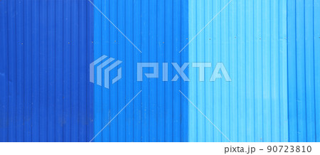 Wave Sheets fence of dark blue, blue and cyan colors. Horizontal background with galvanized iron sheets Wave Sheets fence of dark blue, blue and cyan colors. Horizontal background with galvanized iron sheets 90723810