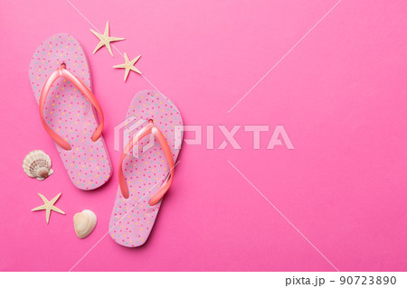 Flat lay composition with flip flops and seashell on colored background. Space for text top view 90723890