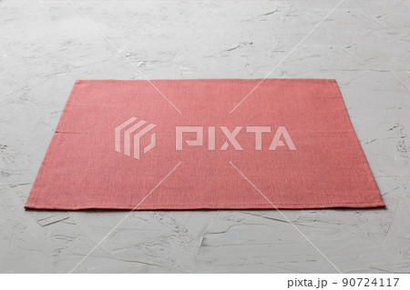 Perspective view of red tablecloth for food on cement background. Empty space for your design 90724117