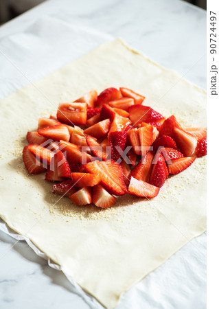 Summer strawberry galette with almond flakes in making. Food preparation concept. 90724497