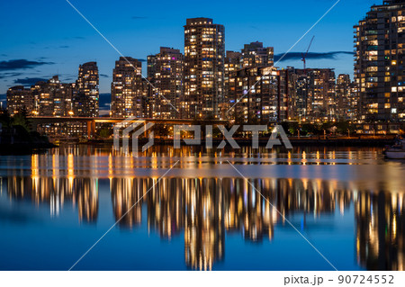 Urban city night, Vancouver twilight skyline. Buildings lights reflection on False Creek water. British Columbia, Canada. 90724552