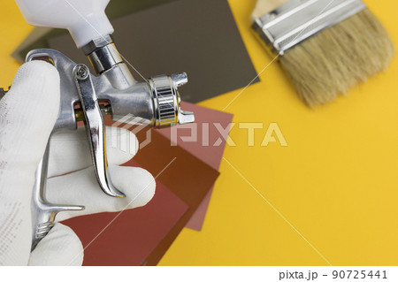 paint spray gun at work at the workplace in the workshop. 90725441