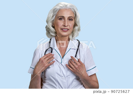 Beautiful smiling doctor woman with stethoscope on light blue background. Beautiful smiling doctor woman with stethoscope on light blue background. 90725627