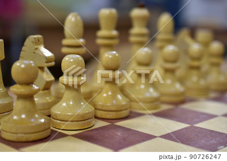 Chessboard with wooden pieces black and white Chessboard with wooden pieces black and white 90726247