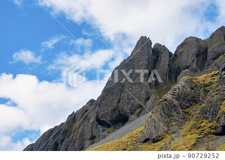 Low angle view of rock formations on volcanic landscape against blue sky Low angle view of rock formations on volcanic landscape against blue sky 90729252