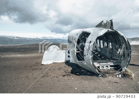 Broken military aircraft wreck at black sand beach in Solheimasandur against sky 90729433
