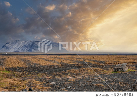 View of mountain on lava sand in Highland against cloudy sky during sunset 90729483